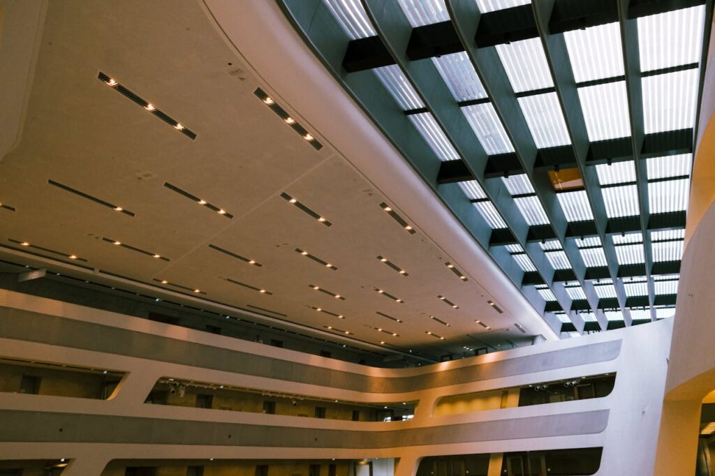 Sleek interior of a modern building with unique glass and steel ceiling.